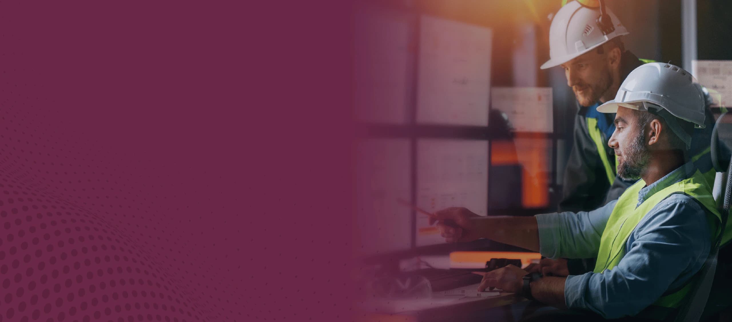 Image of engineers working together, looking at a computer screen